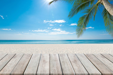 Wooden floor or plank on sand beach. For product display.Calm Sea and Blue Sky Background.tropical...