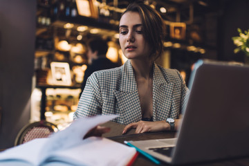 Confident woman working on project in cafe