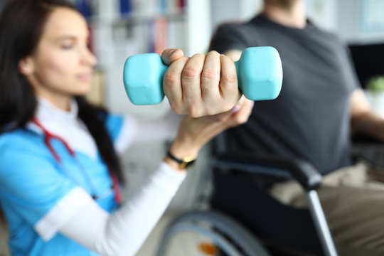 Man on stroller doing exercises with dumbbells