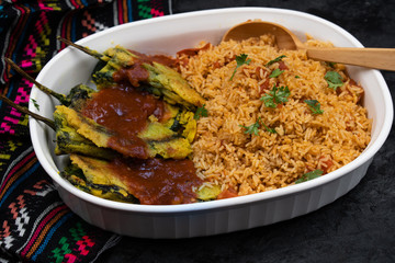 Vegetarian chiles rellenos cooked in eggless batter served with Mexican rice