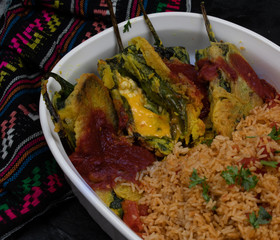 Vegetarian chiles rellenos cooked in eggless batter served with Mexican rice