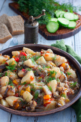 Vegetable stew with potatoes and eggplant in a clay bowl, vegetarian recipe, selective focus