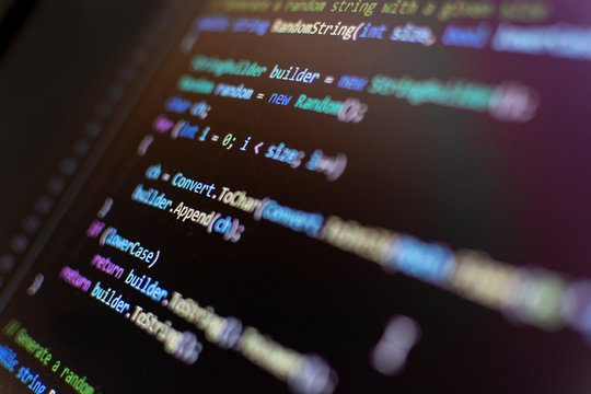 Javascript code in screen on IDE in dark mode. Selective focus.