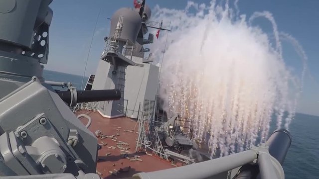 View from the side of a warship at firing from cannons (GoPro)