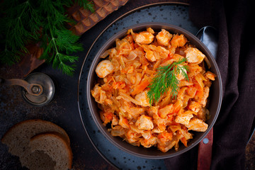 Braised cabbage with chicken breast fillet, top view, selective focus