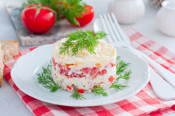 Homemade salad with crab sticks, tomatoes, cheese on a white dish, horizontal