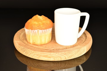 Fresh tasty muffins, close-up, on a black background.