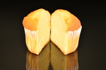 Fresh tasty muffins, close-up, on a black background.