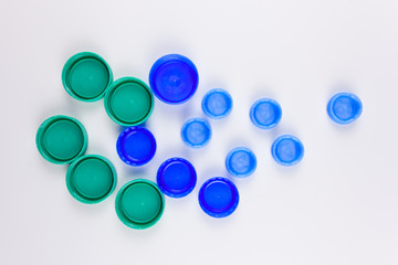 Plastic items. Plastic multicolored bottle caps. For the presentation of waste recycling. Disposable tableware