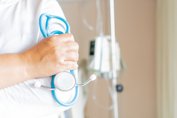 Doctor holding Stethoscope for checking treatment patient with saline drip medical, IV solution, Intravenous therapy for patient in hospital,Stethoscope is acoustic medical device for auscultation