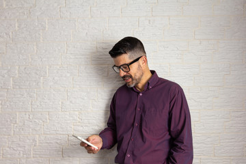 Joyful mature man checking smart cell phone and smilling. Technology, social media, addiction,...