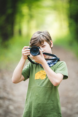 Young boy photographer with camera