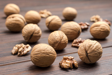 Closeup walnuts on dark wooden background.