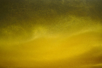 gold paint in water, shiny particles background