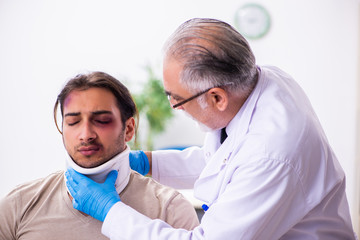 Young face injured man visiting experienced male doctor traumato