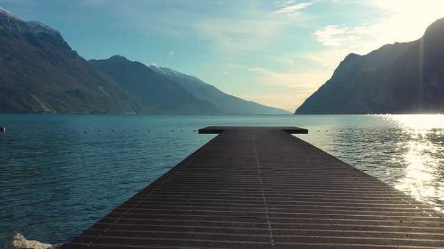 Aerial video with drone, view of the beautiful Lake Garda lake surrounded by mountains in the autumn time , Trentino Alto Adige region, Lago di garda, italy