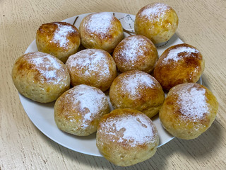Homemade buns sprinkled with powdered sugar
