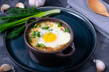 Garlic bread soup with egg baked in the oven in a portion saucepan