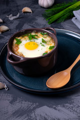 Garlic bread soup with egg baked in the oven in a portion saucepan