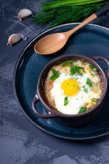 Garlic bread soup with egg baked in the oven in a portion saucepan