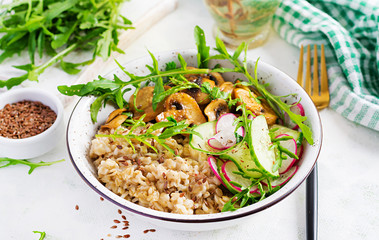Vegan food. Breakfast oatmeal porridge with green herbs of mushrooms, cucumber, radish and flax seeds. Healthy balanced food.