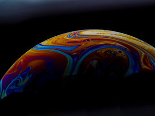 Orange and red colored soap bubble