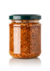 red basil pesto sauce in glass jar