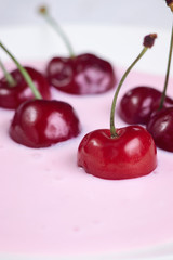 Red cherry in yogurt close-up, healthy breakfast and good morning mood