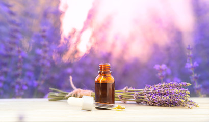 Essential lavender oil in the bottle with dropper isolated on white background. Horizontal close-up. Skincare spa massage.