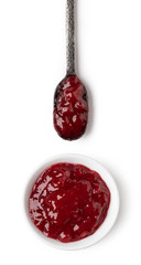 Small glass bowl and spoon of red berry jam