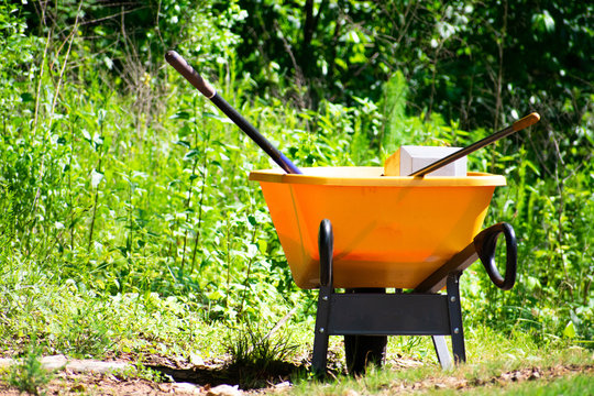 A yellow wheelbarrow for yard work