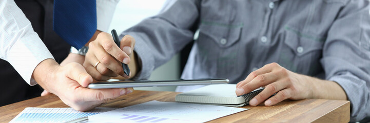 Signing electronic document on tablet with stylus.