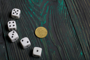 Dice in white with black dots and a coin. On brushed pine boards.