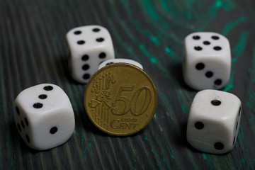 Dice in white with black dots and a coin. On brushed pine boards.