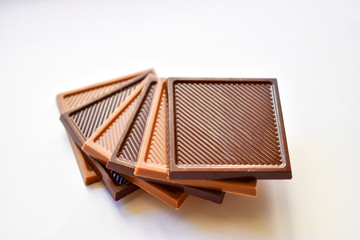 Square shaped milk and dark chocolate isolated on white background