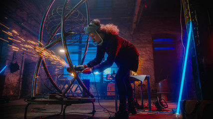 Beautiful Female Artist Uses an Angle Grinder to Make Brutal Metal Sculpture in Studio. Tomboy Girl...