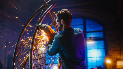 Shot of Talented Innovative Artist Using an Angle Grinder to Make an Abstract, Brutal and...