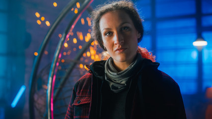 Young Beautiful Empowering Woman with Ear Piercing Gently Smiles at the Camera. Authentic...