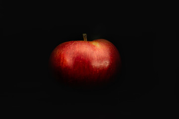 red apple on black background