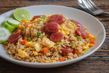 Fried rice with chinese sausage on plate .