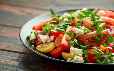 Tomato salad with feta cheese, spring onion and parsley. Healthy summer food