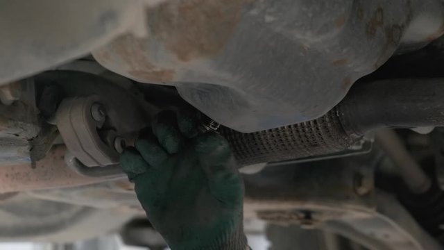 Close up view of motor oil pouring from crankcase. Car maintenance mechanic drain used car engine oil