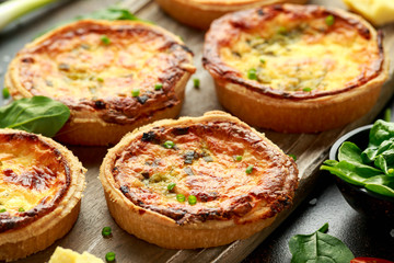 Cheddar cheese and spring onion omelette tarts served on wooden board with side salad. Healthy breakfast food