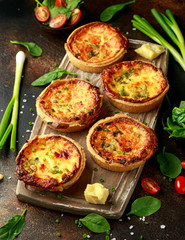 Cheddar cheese and spring onion omelette tarts served on wooden board with side salad. Healthy breakfast food