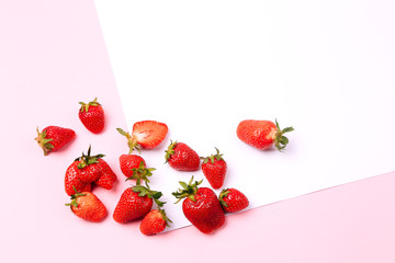 Seamless pattern with strawberry on pink and white background.