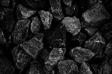 Natural fire ashes with dark grey black coals texture. It is a flammable black hard rock.  Space...