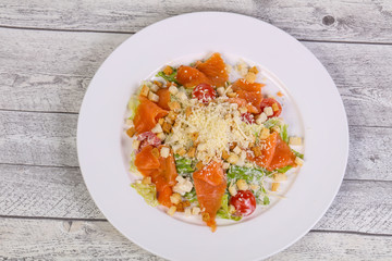 Caesar salad with salmon and parmesan