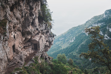 Fototapeta na wymiar Antique house in the rock. Path of the Gods (Sentiero degli Dei) Trekking route from Agerola to Nocelle, Campania, Italy
