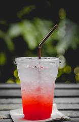 Chill out with strawberry soda cocktail on wood table at the Cafe for fresh summer or relax time after hard working. Vintage tone with fade background. Free space for input your text.