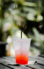 Chill out with strawberry soda cocktail on wood table at the Cafe for fresh summer or relax time after hard working. Vintage tone with fade background. Free space for input your text.